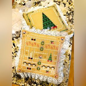 Two hand cross stitched Christmas pillows with green velveteen back.